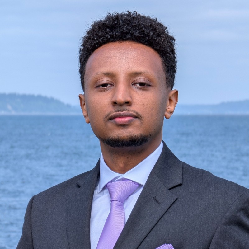 Self-portrait photograph of Nebiyou Hailemariam at his desk